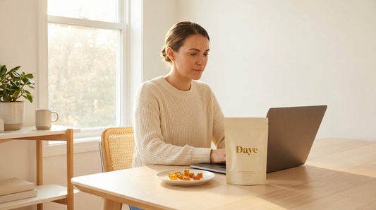 Focused woman at desk with laptop and Daye creatine pouch