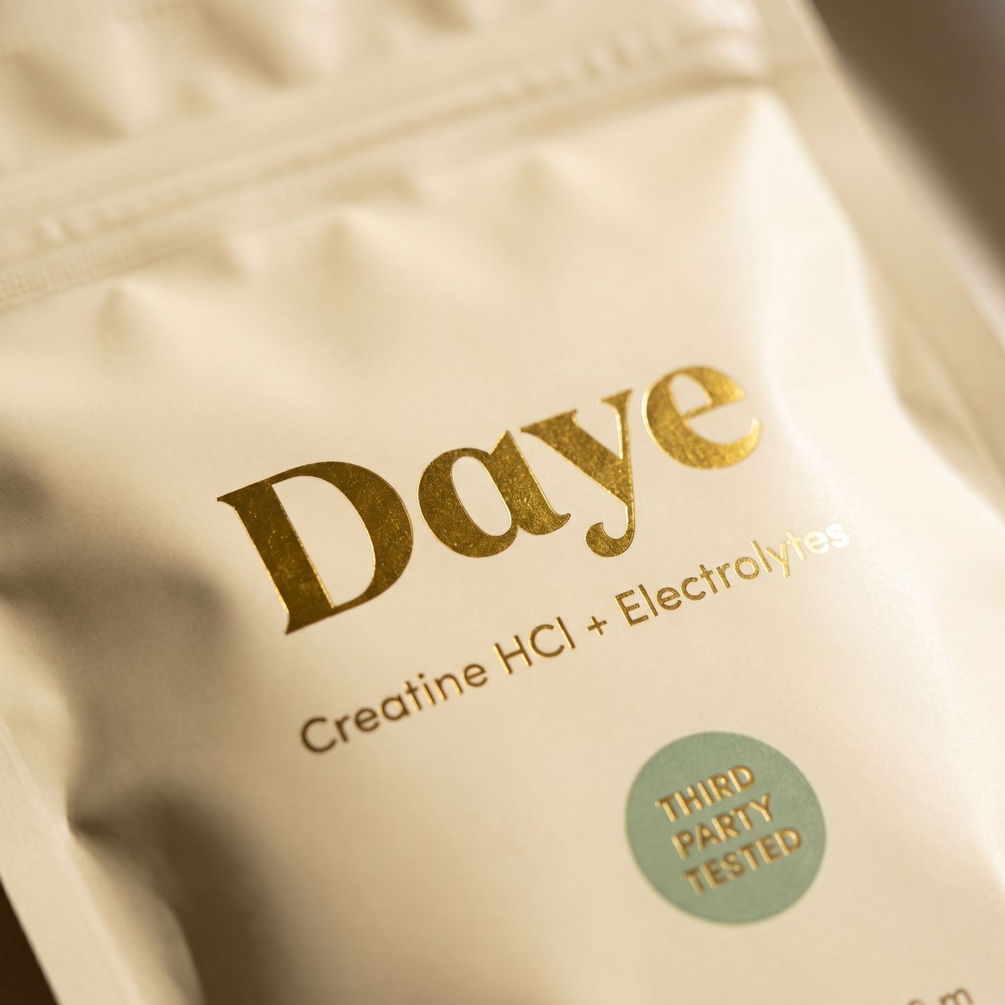 Daye Core gold foil packaging detail — premium creatine HCl supplement branding close-up