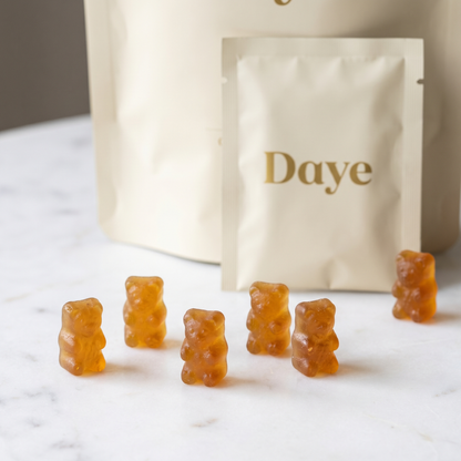 Amber bear-shaped creatine HCl gummies on marble surface with Daye packaging